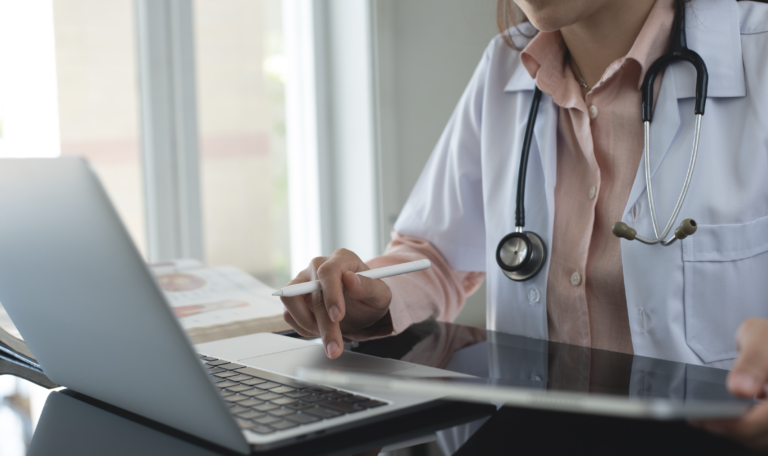 Healthcare provider using a laptop and tablet to share their profile link on House Call The App